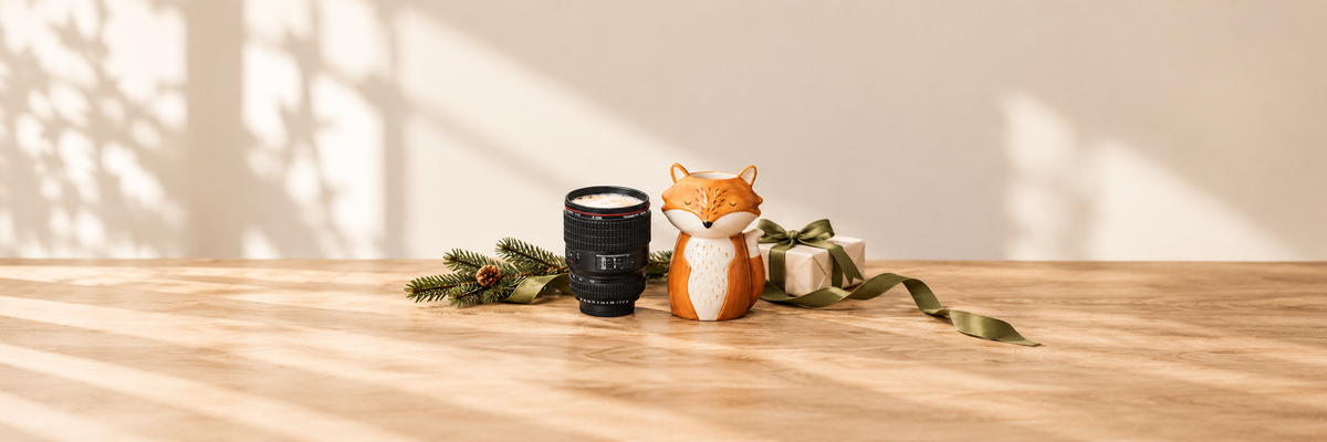 Camera lens mug and Finley Fox vase beside an ivory Christmas gift with olive ribbon.
