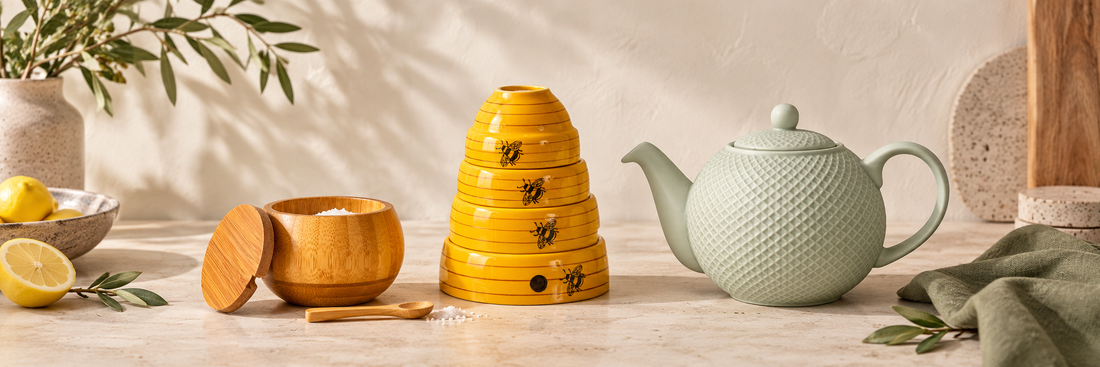 Yellow beehive measuring bowls, bamboo spice jar and green teapot
