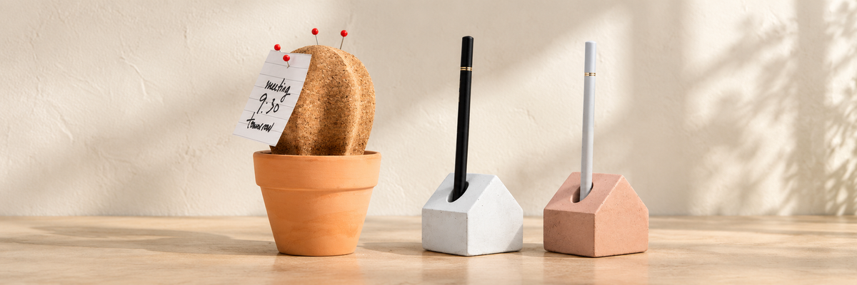 Concrete Pen House - Pink & White and Cork Cactus Desk Organiser arranged in a warm, softly lit setting.