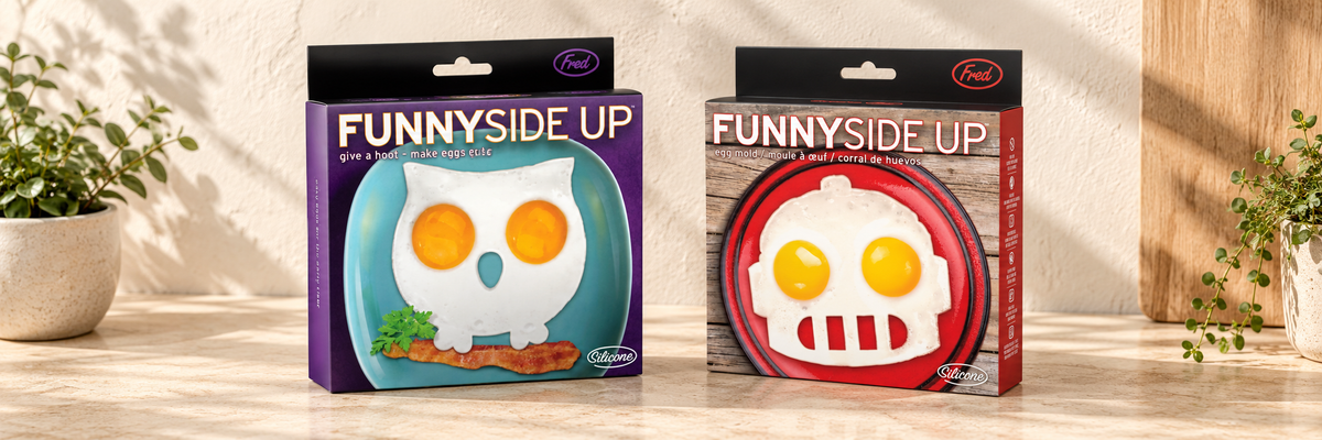 Funny Side Up Owl Egg Mould and Funny Side Up Robot Egg Mould arranged in a warm, softly lit setting.
