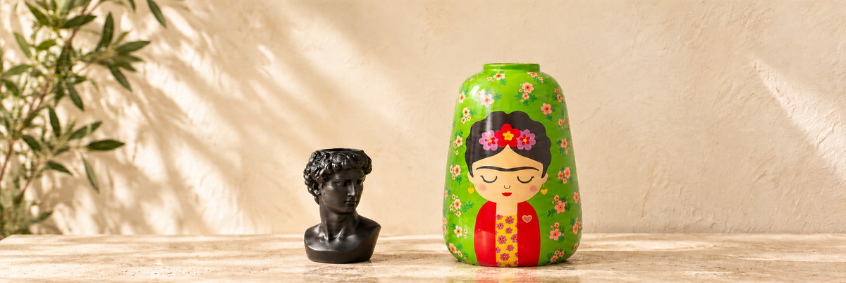 Greek Head Vase - Small, Black and Floral Frida Large Vase arranged in a warm, softly lit setting.