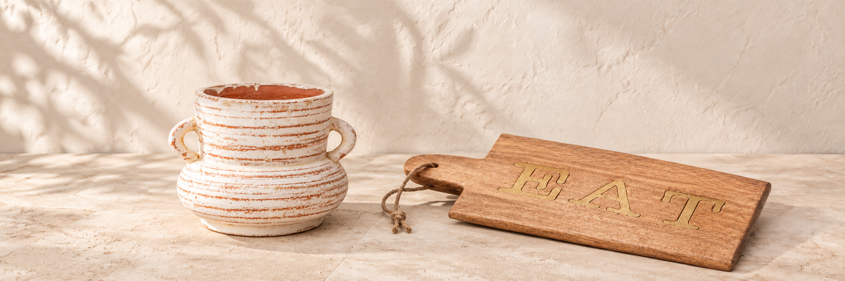 Daphne Amphora Vase - Whitewashed Terracotta and Mango Wood Paddle Serving Board arranged in a warm, softly lit setting.