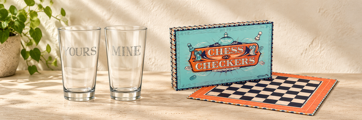 Stir It Up Mine &amp; Yours Highball Glasses - Pair and Retro Chess &amp; Checkers arranged in a warm, softly lit setting.