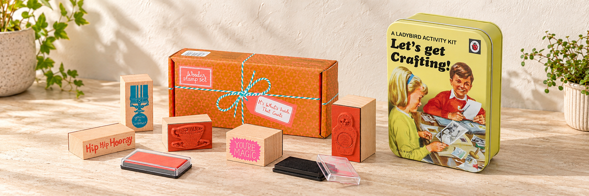 Hazel Nicholls Wooden Stamp Set and Ladybird Let’s Get Crafting Kit arranged in a warm, softly lit setting.