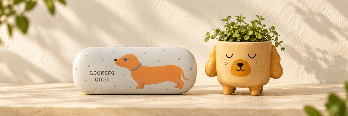 Dachshund Glasses Case and Mini Cockapoo Planter on Legs arranged in a warm, softly lit setting.