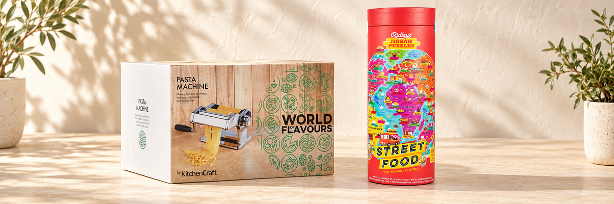 World of Flavours Double-Cutter Pasta Machine and Street Food 1000 Pieces Jigsaw Puzzle arranged in a warm, softly lit setting.