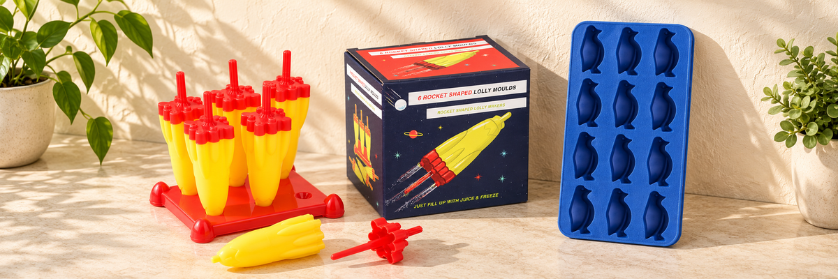 Space Age Rocket Ice Lolly Moulds and Flexible Penguin Shape Ice Cube Tray arranged in a warm, softly lit setting.