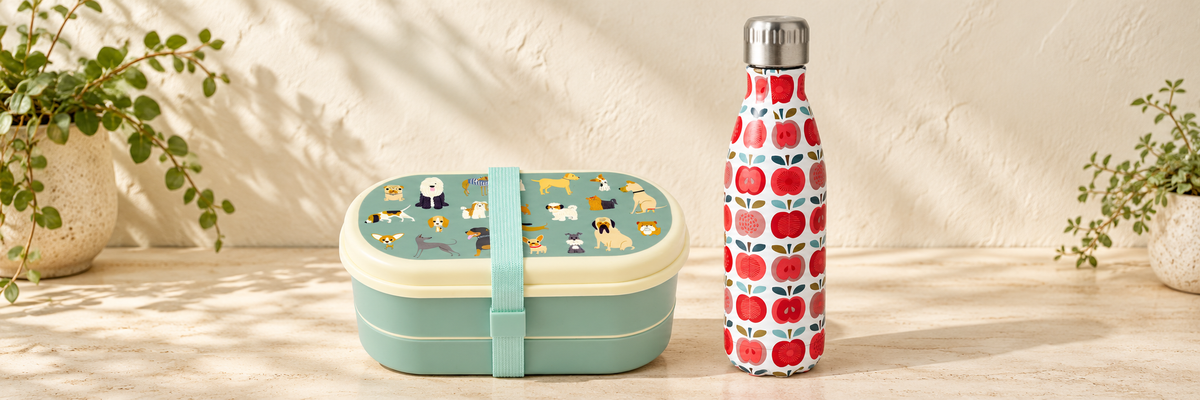 Best in Show Two-Compartment Bento Box and Vintage Apple Stainless Steel Bottle - 500ml arranged in a warm, softly lit setting.