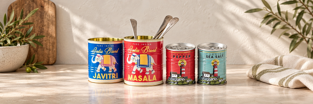 Colourful retro storage tins and salt and pepper tins on a pale wooden table