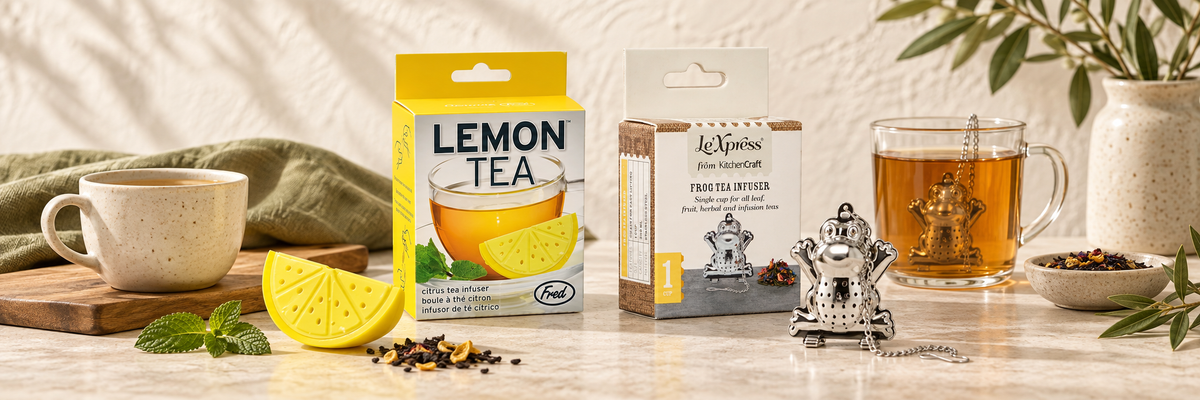 Lemon and frog tea infusers beside tea cups and packaging