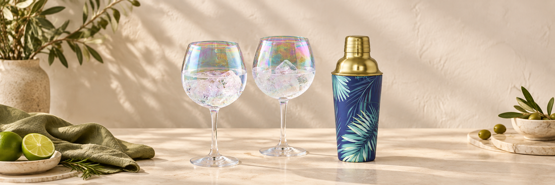 Iridescent stemmed glasses beside a blue and gold cocktail shaker