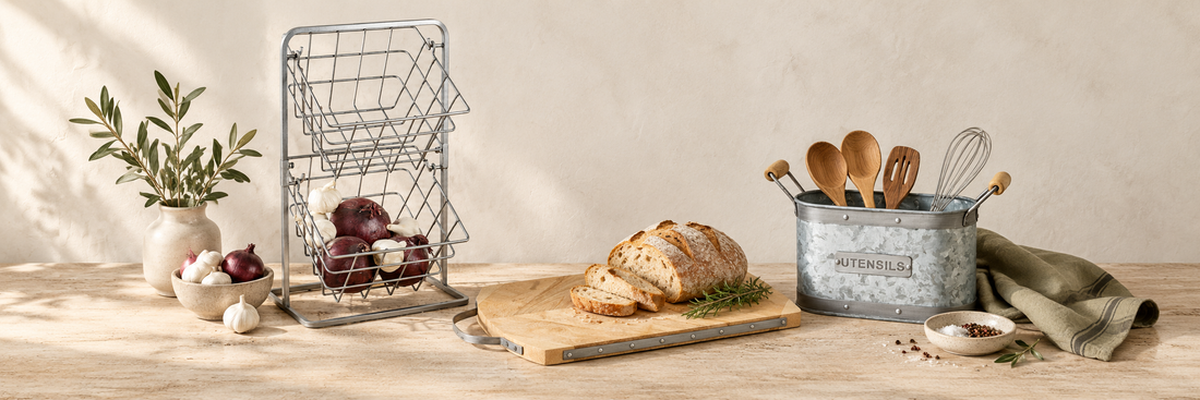 Wire storage basket, wooden board and metal utensil holder in a kitchen