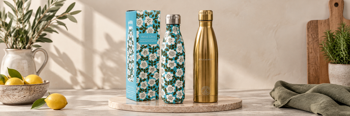 Patterned blue bottle beside a gold stainless steel bottle