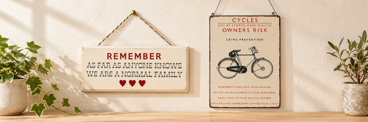 Family Home Wooden Hanging Sign and Vintage Bicycle Hanging Metal Sign arranged in a warm, softly lit setting.