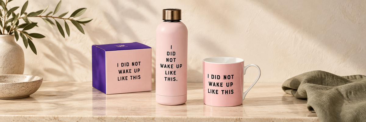 Pink travel cup and bottle beside a purple gift box