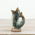 Portland Living two-tone fish vase with blue-green and brown glaze on a wooden surface