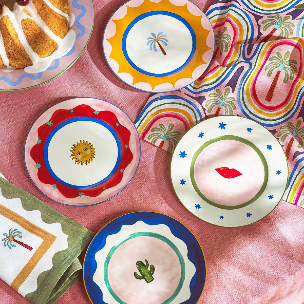 Eleanor Bowmer Electric Coast cake plates arranged on a colourful table setting